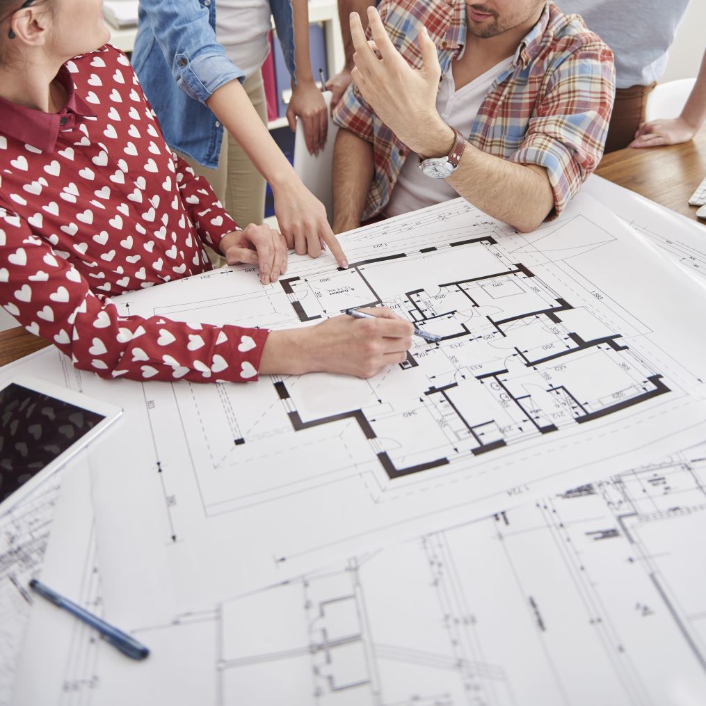 coworkers-office-with-architecture-plans-computer