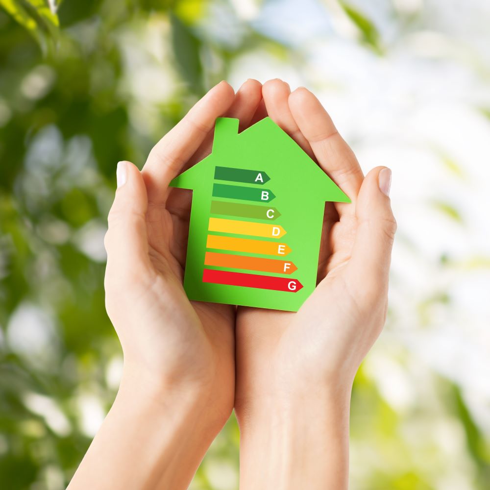 energy-saving-real-estate-family-home-concept-closeup-female-hands-holding-green-paper-house-with-energy-efficiency-rating1